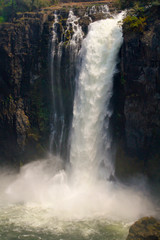 Fototapeta na wymiar The Victoria Falls are a wide waterfall of the Zambezi River between the border towns of Victoria Falls in Zimbabwe and Livingstone in Zambia.