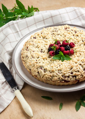 Berry shortcrust pie with crumble on a plate