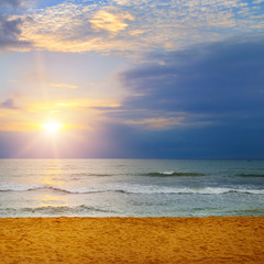 Beach of the ocean and sunrise.