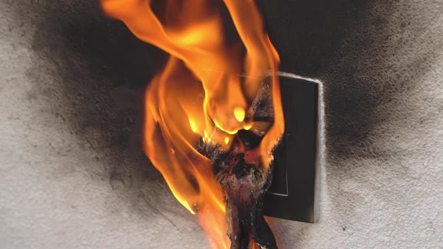 burning socket from short circuit in house. concept of fire in apartment.