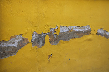 Old yellow wall of a building with cracks, background. Repair of buildings and structures.