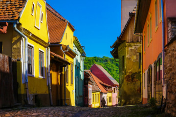 Sighisoara, Romania, May 12, 2019: Beautiful colorful street in Sighisoara in typical traditional...