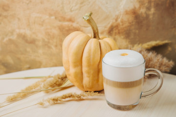 Pumpkin Spice Latte. Cup of Latte with Pumpkin and Fall Decor. Traditional Autumn Coffee Drink.