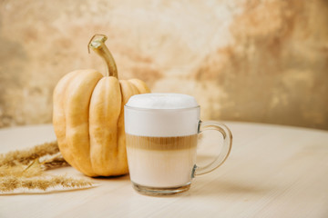 Pumpkin Spice Latte. Cup of Latte with Pumpkin and Fall Decor. Traditional Autumn Coffee Drink.