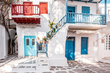 Typical Greek architecture in the white, cobbled alleys of Mykonos town, houses in the old town of Chora with colorful balconies and white churches, Cyclades, Greece