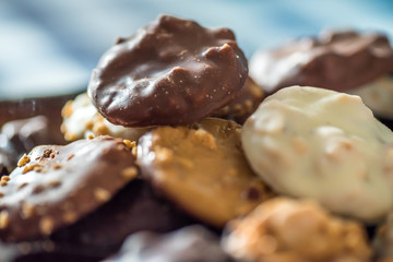 closeup view of pile of nuts covered with chocolate on plate