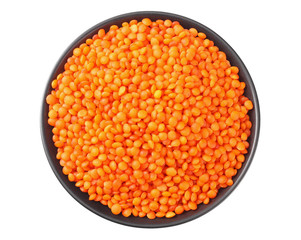 Pile lentil in black bowl isolated on white background. Top view.
