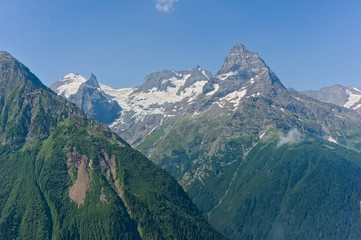 Mountain peak in black, covered with glaciers and snow. Dombay, Russia