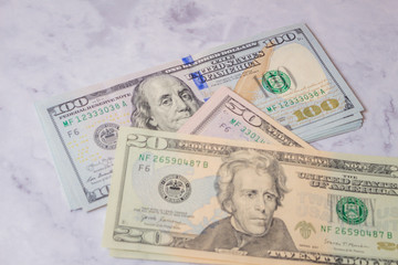 close up view of cash money dollars bills in amount. 100, 50, 20, 10