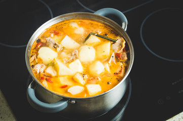 stewed potatoes, roast at home from rabbit in a saucepan on the stove