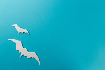 Halloween decorations. Halloween paper decorations on pastel blue background. Top view. Flat lay of accessory decoration Halloween festival. Copy space. Minimal creative concept. Pastel colors