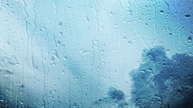 Storm clouds time lapse with rainy wet window. Bad weather background.