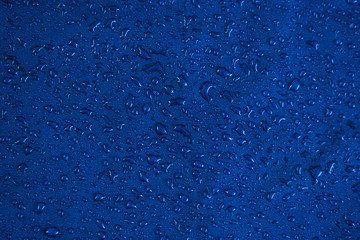 View texture blue synthetic waterproof clothing.Water drops on waterproof nylon. Rain drops on...