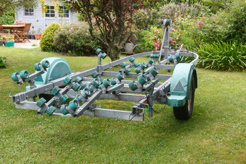 Empty boat trailer parked in a garden