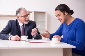 Male real estate agent and male client in the apartment