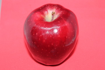 One Whole Red Delicious Apple on a Pink Background