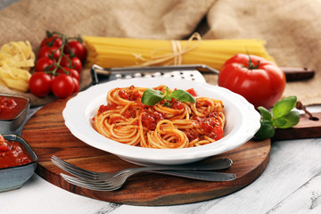 Plate of delicious spaghetti Bolognaise or Bolognese with savory minced beef and tomato sauce garnished with parmesan