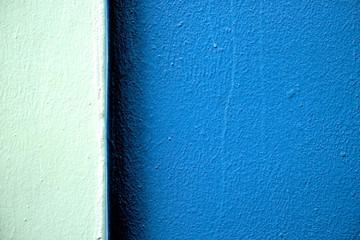Two tones of blue color bands on a freshly painted wall in hard light, offset with large darker...