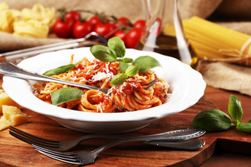 Plate of delicious spaghetti Bolognaise or Bolognese with savory minced beef and tomato sauce garnished with parmesan
