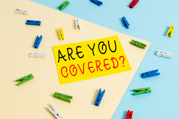 Text sign showing Are You Covered Question. Business photo text asking showing if they had insurance in work or life Colored clothespin paper empty reminder yellow blue floor background office