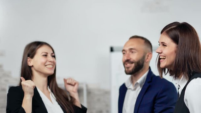 Team of business people making winner gesturing clapping hand together having positive emotion