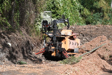 A big machine for shredding wood in use in a forest near Berlin-Germany.