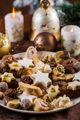 Assorted Christmas cookies with candles on the table