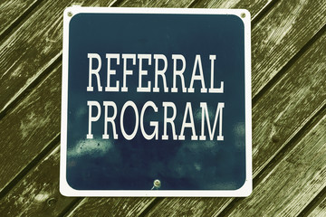 Handwriting text writing Referral Program. Conceptual photo employees are rewarded for introducing suitable recruits Empty blue board with copy space above wooden background