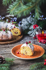 Obraz na płótnie Canvas Traditional homemade christmas cake holiday dessert with cranberry and chocolate with new year tree decoration on vintage wooden table background. Rustic style.