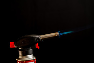 Naklejka premium Flame gas burner dark background DIY tools