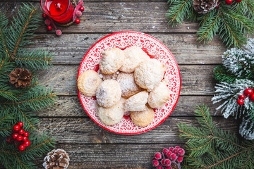 Homemade Christmas cookies in a red plate with festive decoration