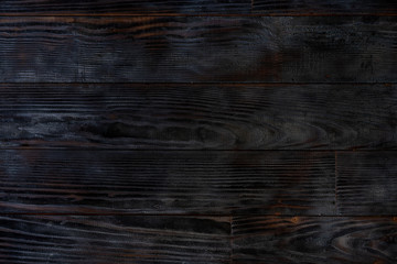 Obraz premium BBQ background. Burnt wooden Board texture. Burned scratched hardwood surface.