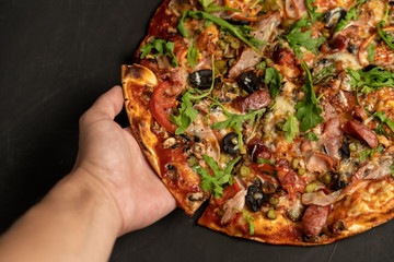 Appetizing pizza with smoked sausages bacon meat tomato cheese arugula