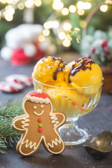Glass bowl with delicious citrus ice cream on christmas background