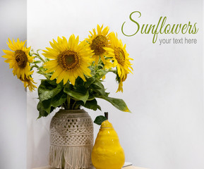 Vase with sunflowers close-up with a place for an inscription. Bouquet of sunflowers on the table