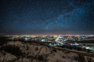 City at night against the background of the starry sky