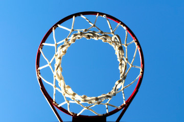 basketball net and hoop outdoors of sunny day against the blue sky, bottom view © Romo Lomo