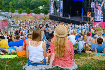 Couple is watching concert at open air music festival