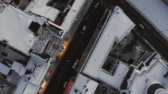 Winter, roads, cars. Snowy roofs and streets of a big Russian city from above. Natural lighting, multicopter shooting.