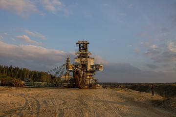 Fototapeta premium multi-bucket excavator giant at limestone quarry in summer day