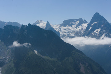 Mountain peak in black, covered with glaciers and snow. Dombay, Russia
