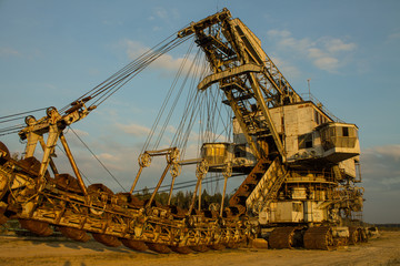 multi-bucket excavator giant at limestone quarry in summer day