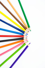 colored pencils on a white background folded in a semicircle