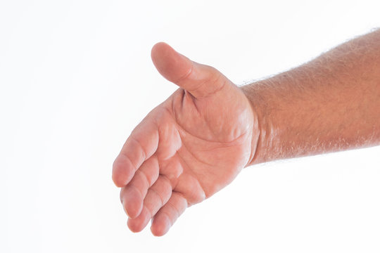 Colorful photo of a man's hand shaking in the form of a greeting on a white background. Space to write.