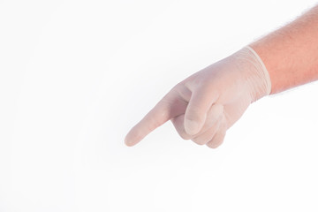 A hand covered by a glove pointing to the ground on a white background. Space to write.