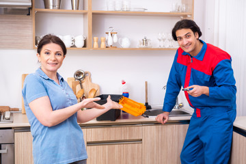 Young male repairman repairing tap