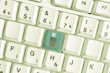 Writing note showing We Need You. Business concept for asking someone to work together for certain job or target White pc keyboard with note paper above the white background