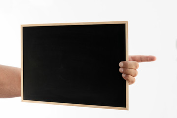 A blackboard with a wooden edge held by a man's hand on a white background.