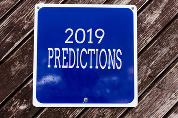 Obraz premium Handwriting text writing 2019 Predictions. Conceptual photo statement about what you think will happen in 2019 Empty blue board with copy space above wooden background