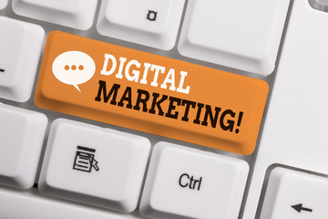 Text sign showing Digital Marketing. Business photo showcasing market products or services using technologies on Internet White pc keyboard with empty note paper above white background key copy space